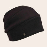 Black beanie hat on a beige background