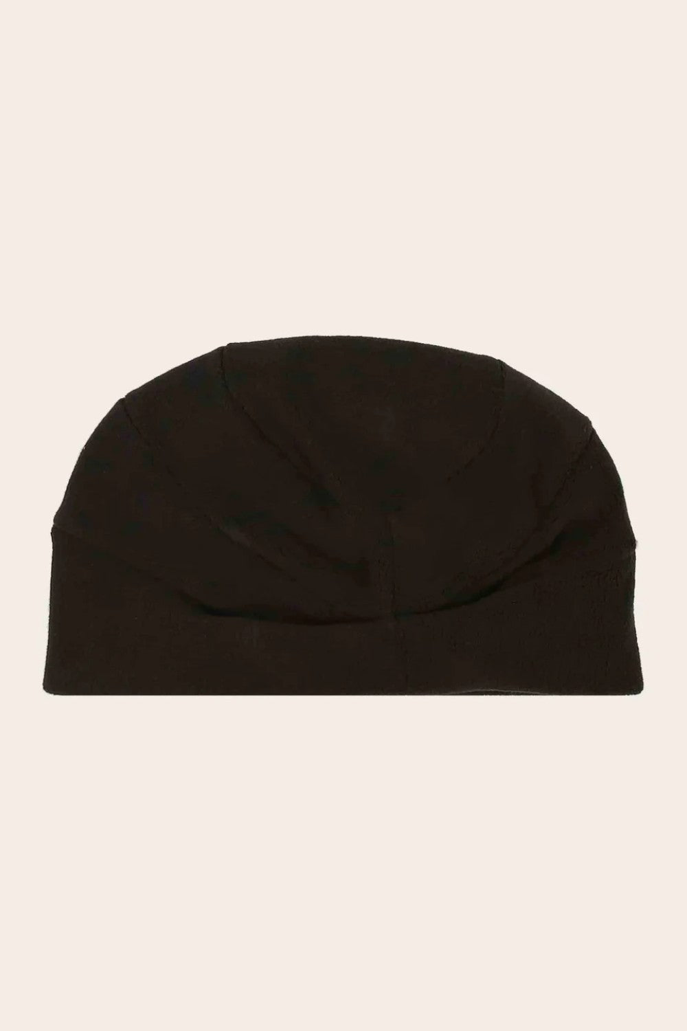 Black beanie on a beige background