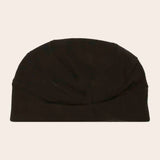 Black beanie on a beige background