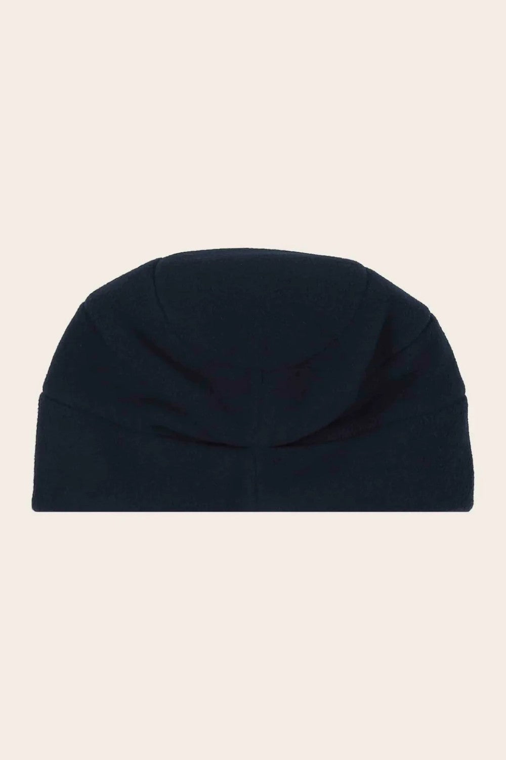 Navy blue beanie hat on a beige background