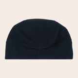 Navy blue beanie hat on a beige background