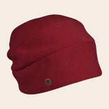 Red beanie hat with a small logo on a beige background