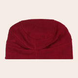 Red beanie on a beige background