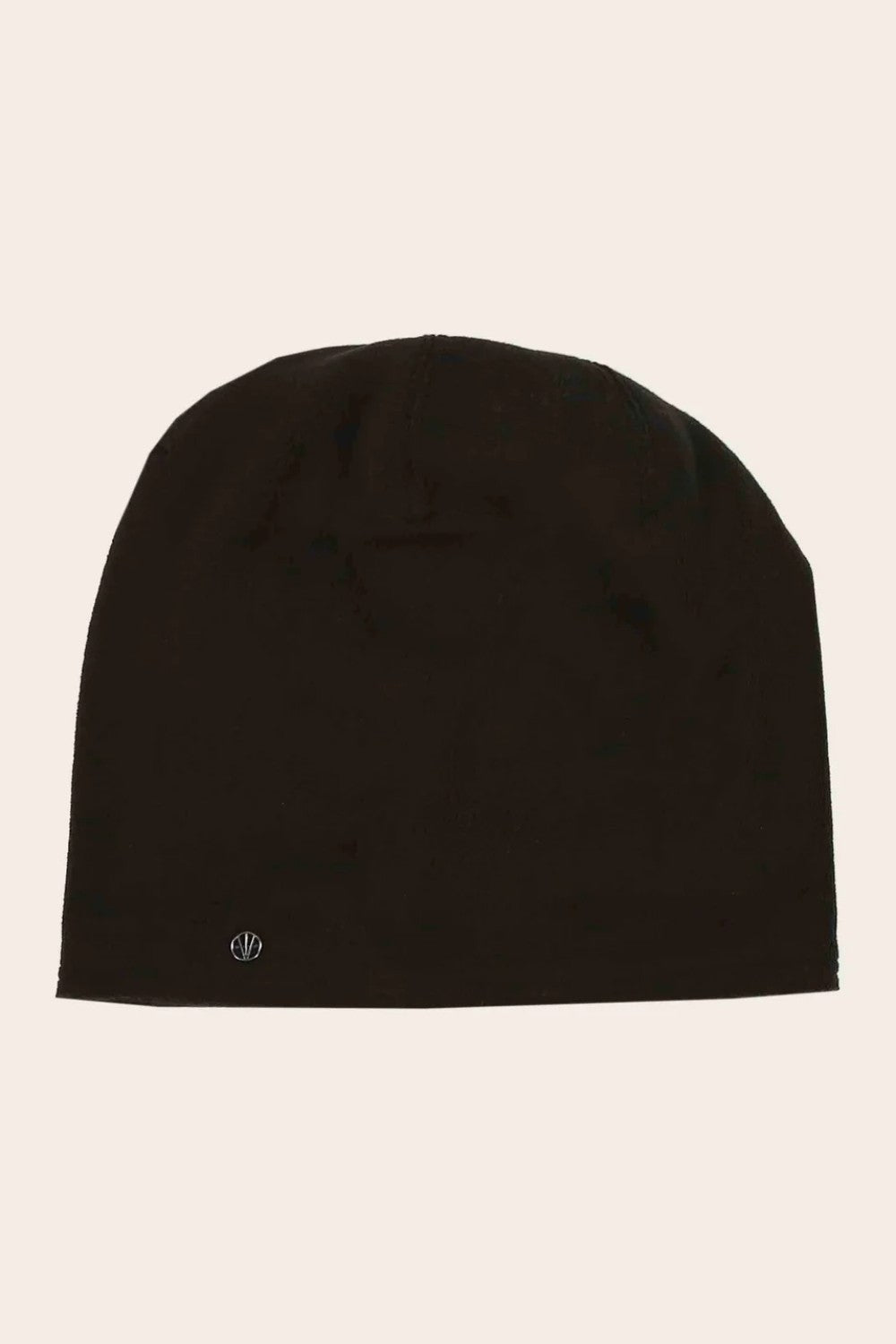 Black beanie hat on a beige background