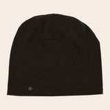 Black beanie hat on a beige background