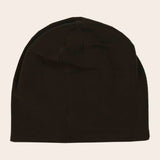 Black beanie hat on a beige background