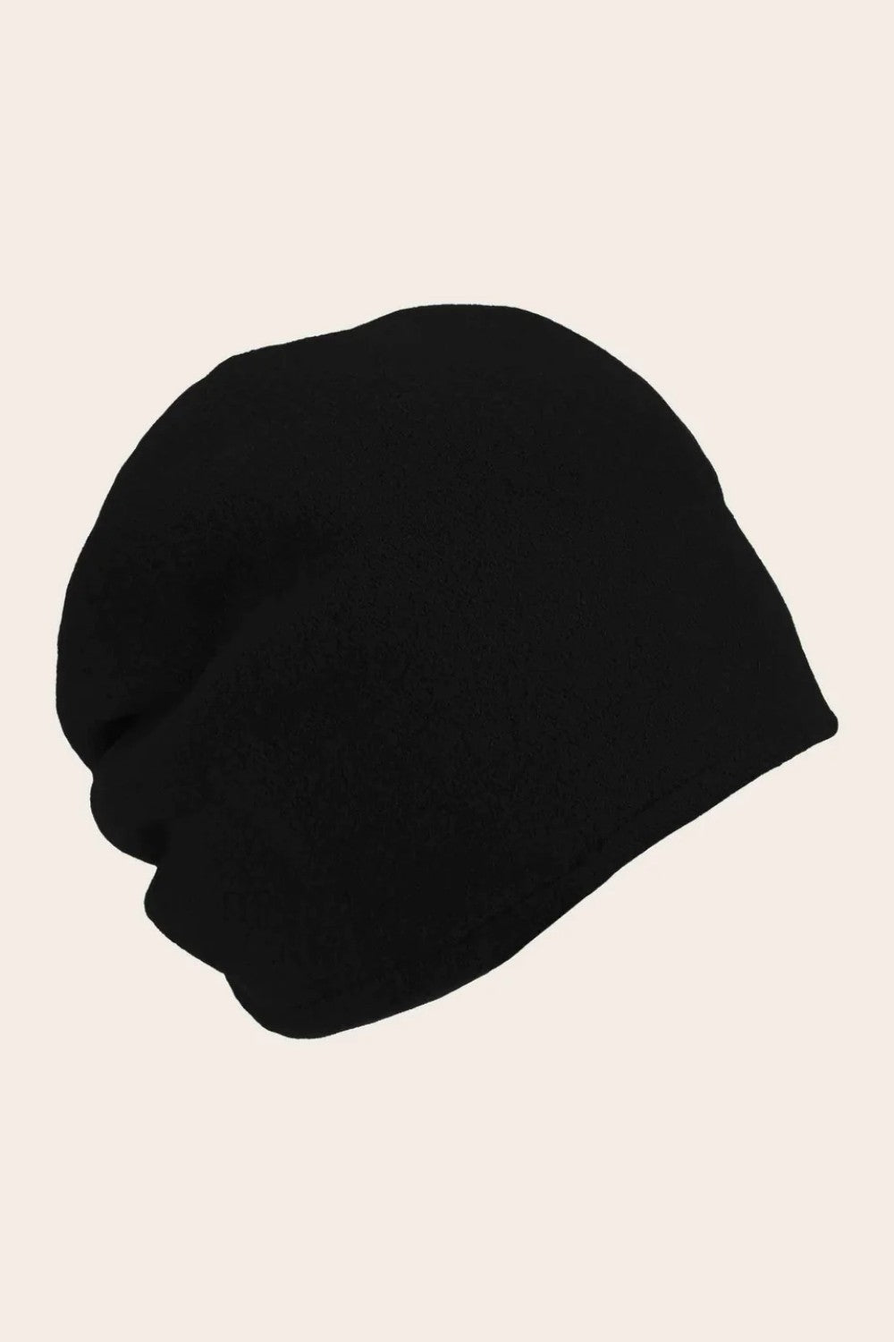 Black beanie hat on a beige background