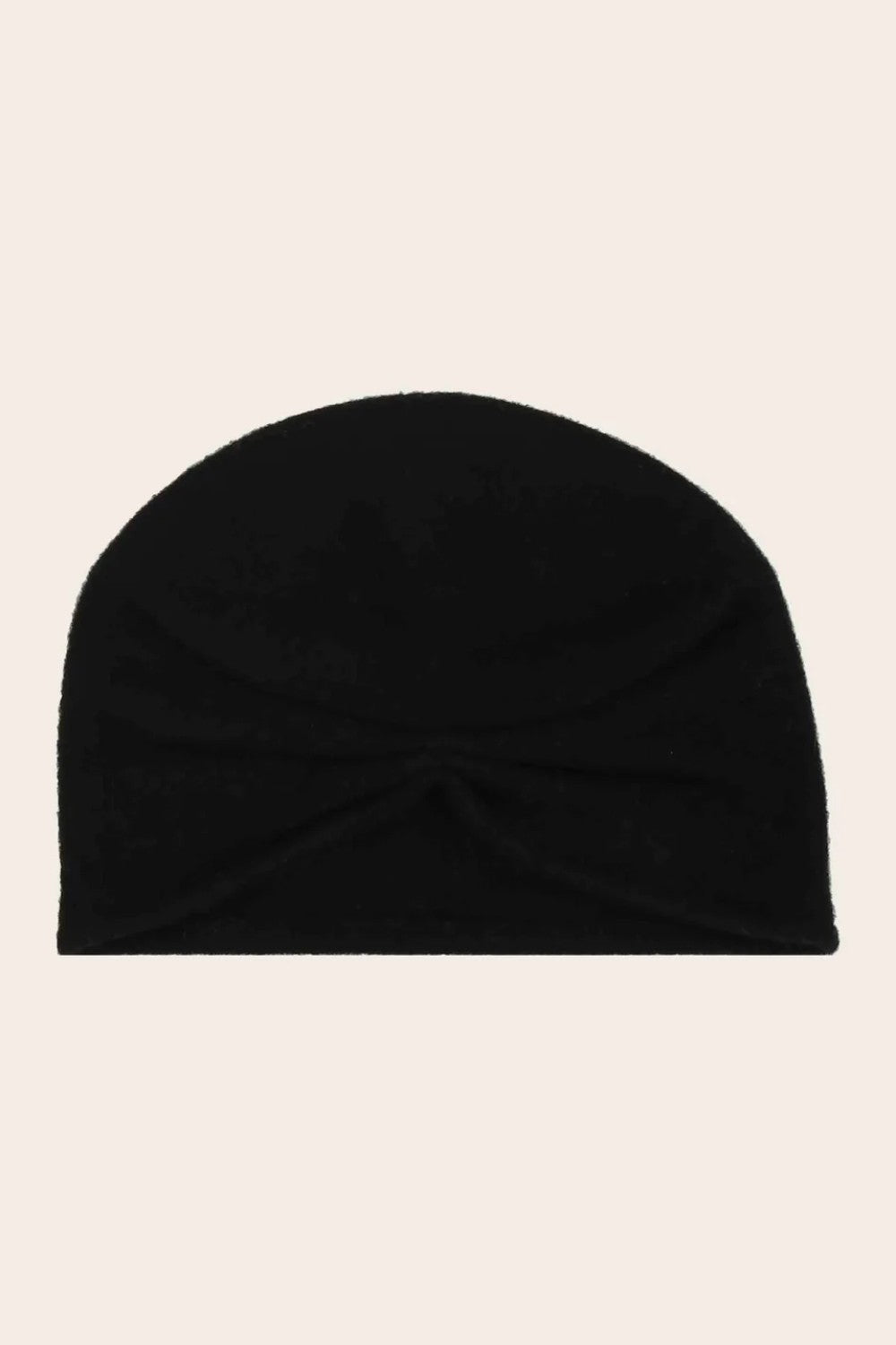 Black beanie on a beige background