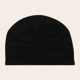 Black beanie on a beige background