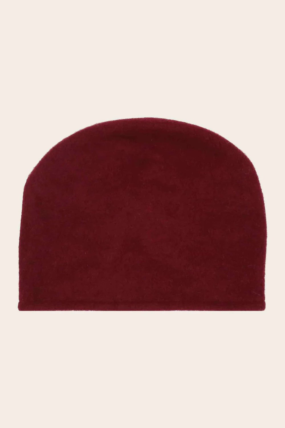 Burgundy beanie hat on a beige background