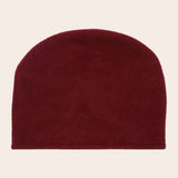 Burgundy beanie hat on a beige background