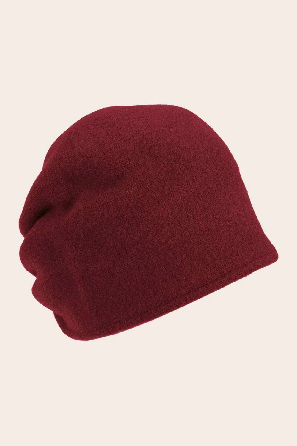 Burgundy beanie hat on a beige background