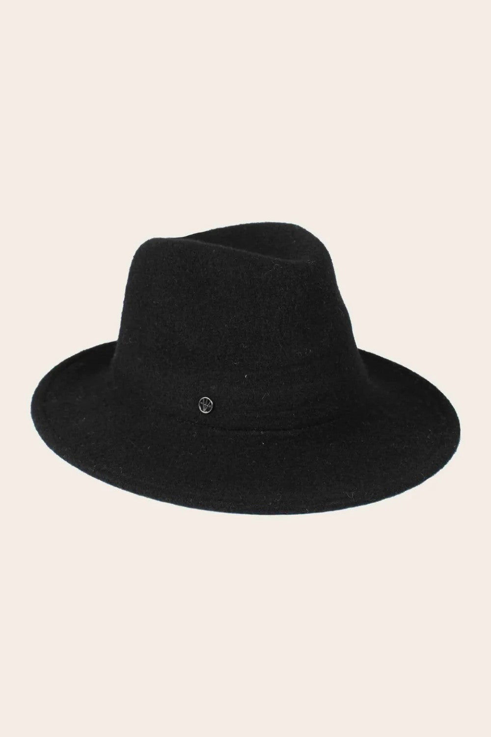 Black fedora hat on a beige background