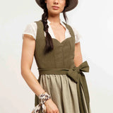 Woman wearing a green dress with a beige skirt and a tan hat on a white background