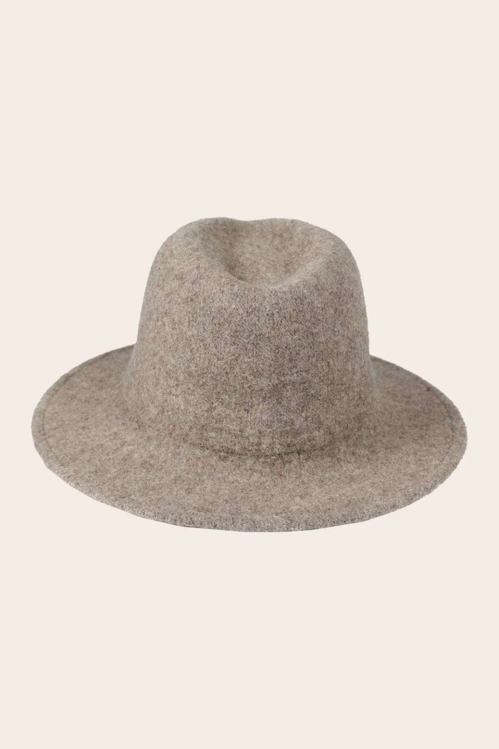Tan fedora hat on a light beige background