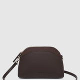 A dark brown pleather crescent-shaped shoulder bag with a matching adjustable strap and gold-tone hardware, shown against a light gray background.