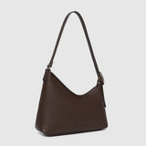 Brown handbag with a strap on a light gray background