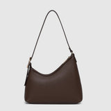 A dark brown leather shoulder bag with a crescent-shaped silhouette and a thin black strap, shown against a light gray background.