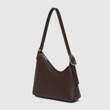 Dark brown hand bag with gold zipper on a light background.