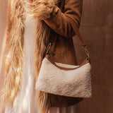 The Louenhide Aspen Shoulder Bag is the soft-structured silhouette your winter wardrobe’s been waiting for. Crafted in a faux shearling texture with warm neutral tones, this sherpa bag brings a subtle warmth to cool-weather dressing. Light gold hardware adds a refined touch to this beige shoulder bag, while the spacious interior easily fits your daily essentials. Whether styled with denim or layered with flowing silhouettes, the Aspen is designed to move with you through the season - statement, elevated, an