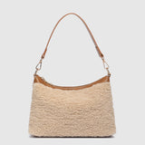 The Louenhide Aspen Shoulder Bag is the soft-structured silhouette your winter wardrobe’s been waiting for. Crafted in a faux shearling texture with warm neutral tones, this sherpa bag brings a subtle warmth to cool-weather dressing. Light gold hardware adds a refined touch to this beige shoulder bag, while the spacious interior easily fits your daily essentials. Whether styled with denim or layered with flowing silhouettes, the Aspen is designed to move with you through the season - statement, elevated, an