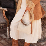 The Louenhide Aspen Shoulder Bag is the soft-structured silhouette your winter wardrobe’s been waiting for. Crafted in a faux shearling texture with warm neutral tones, this sherpa bag brings a subtle warmth to cool-weather dressing. Light gold hardware adds a refined touch to this beige shoulder bag, while the spacious interior easily fits your daily essentials. Whether styled with denim or layered with flowing silhouettes, the Aspen is designed to move with you through the season - statement, elevated, an