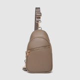 Beige crossbody bag with a strap on a light gray background