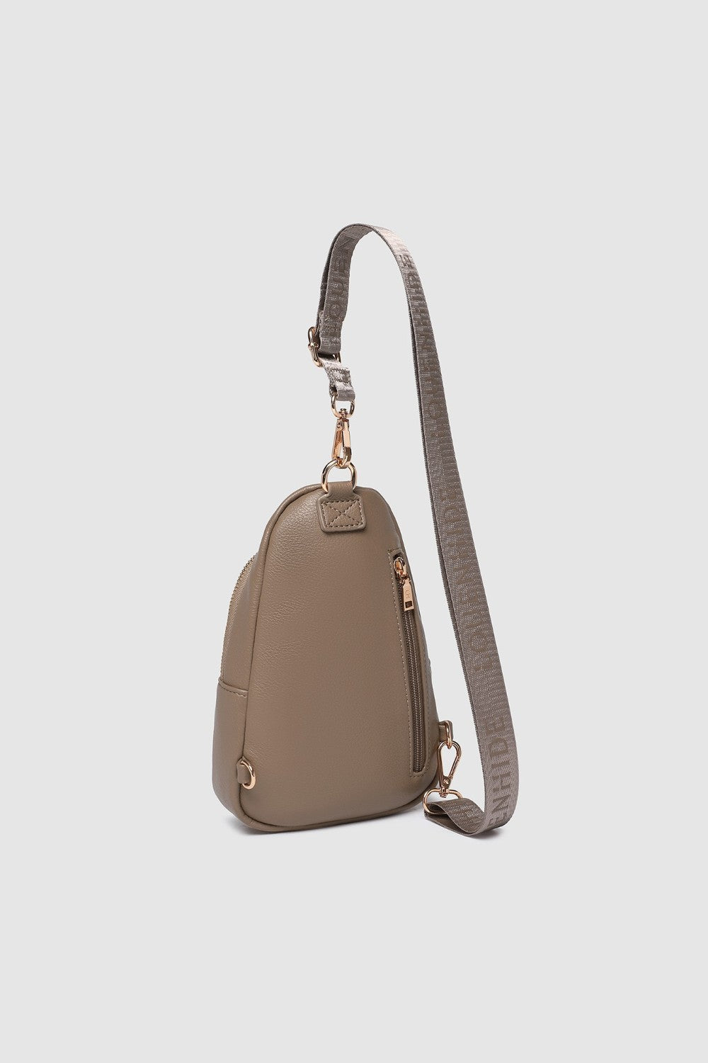 Beige crossbody bag with a strap on a light gray background