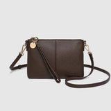 Brown leather crossbody bag on a light gray background