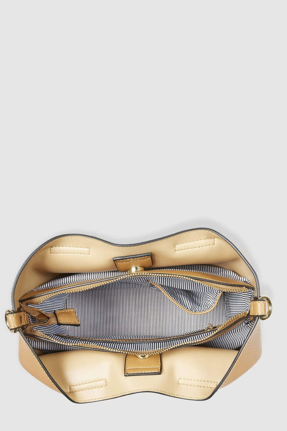 Tan handbag with open flap on a light gray background