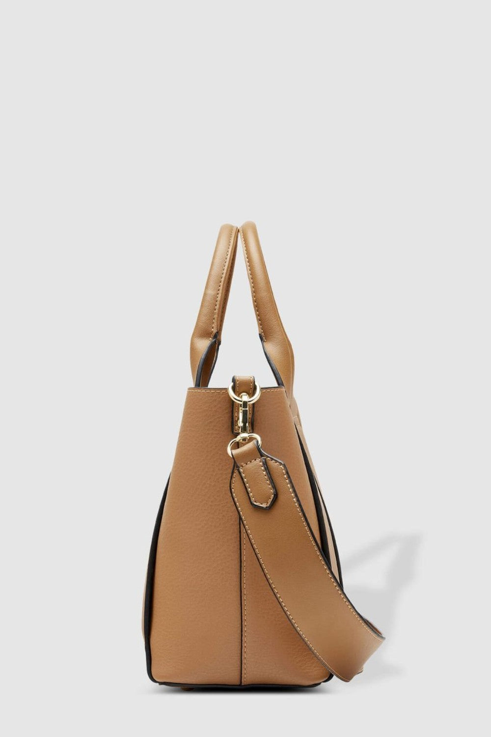 Tan handbag with a shoulder strap on a light gray background