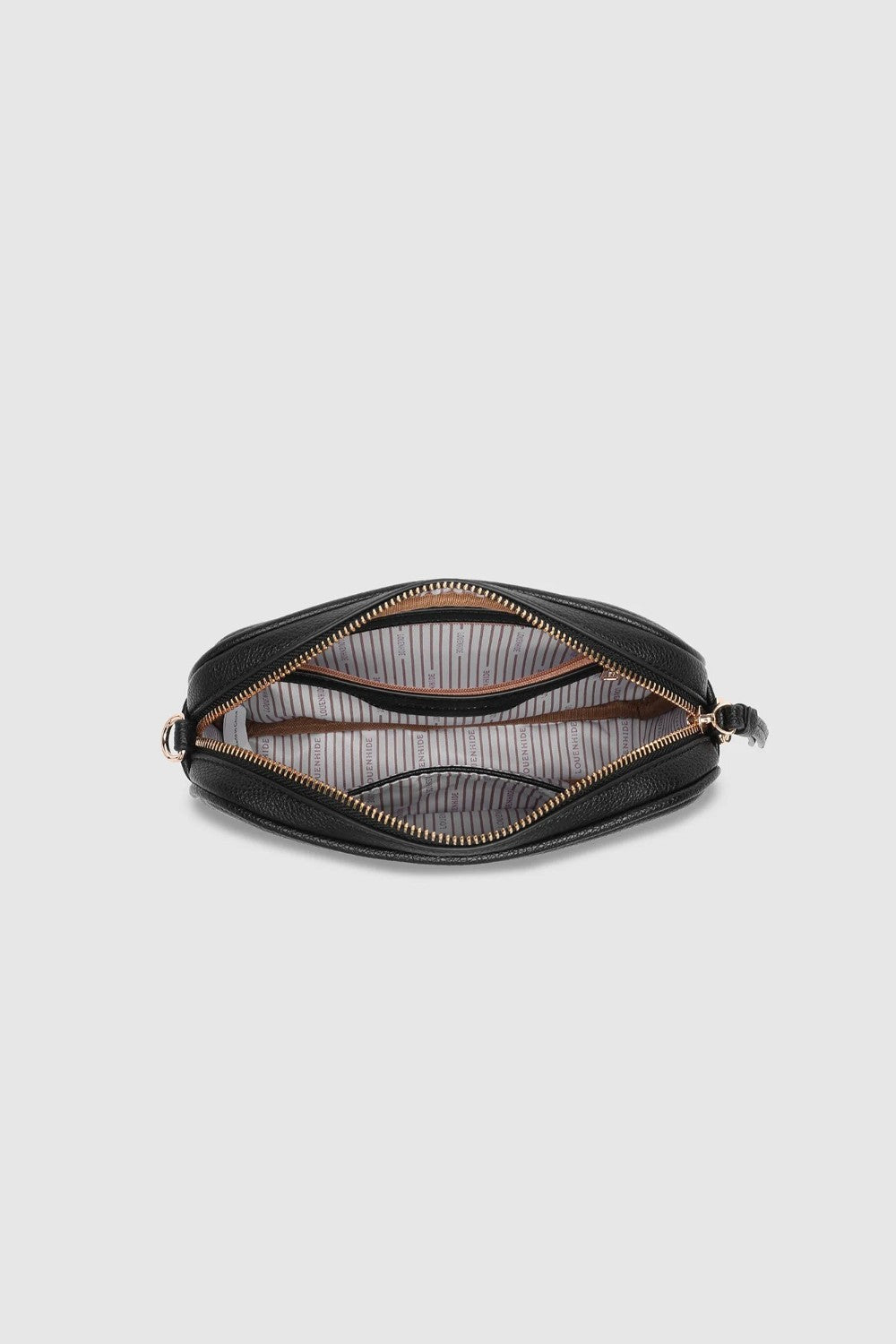 A black zippered bag shown open from a top-down view, revealing a striped interior lining and gold-toned zipper hardware, set against a solid light gray background.