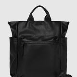 A black pebbled leather backpack with top handles and a detachable shoulder strap, shown against a light gray background.