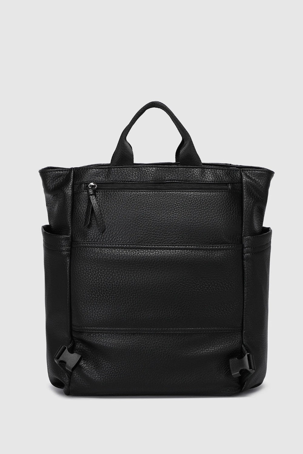 A black pebbled leather backpack with top handles, side pockets, and a front zippered pocket, shown against a light gray background.