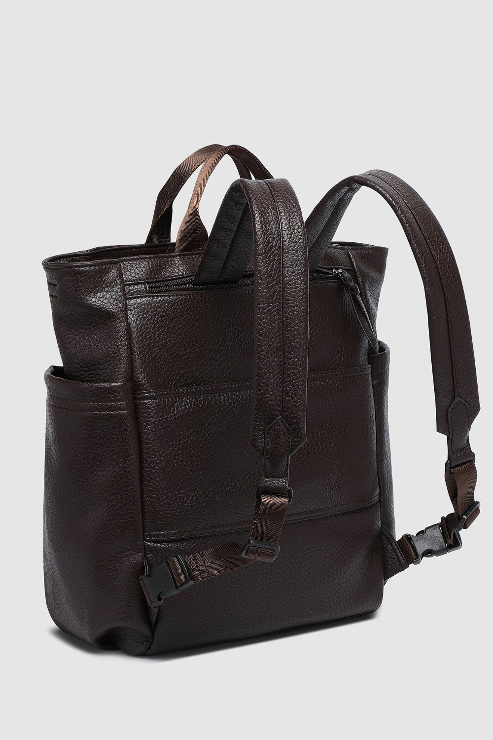 Brown pleather backpack on a light gray background