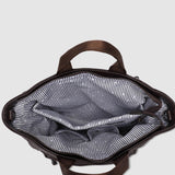 Open brown pleather bag with striped lining on a light gray background