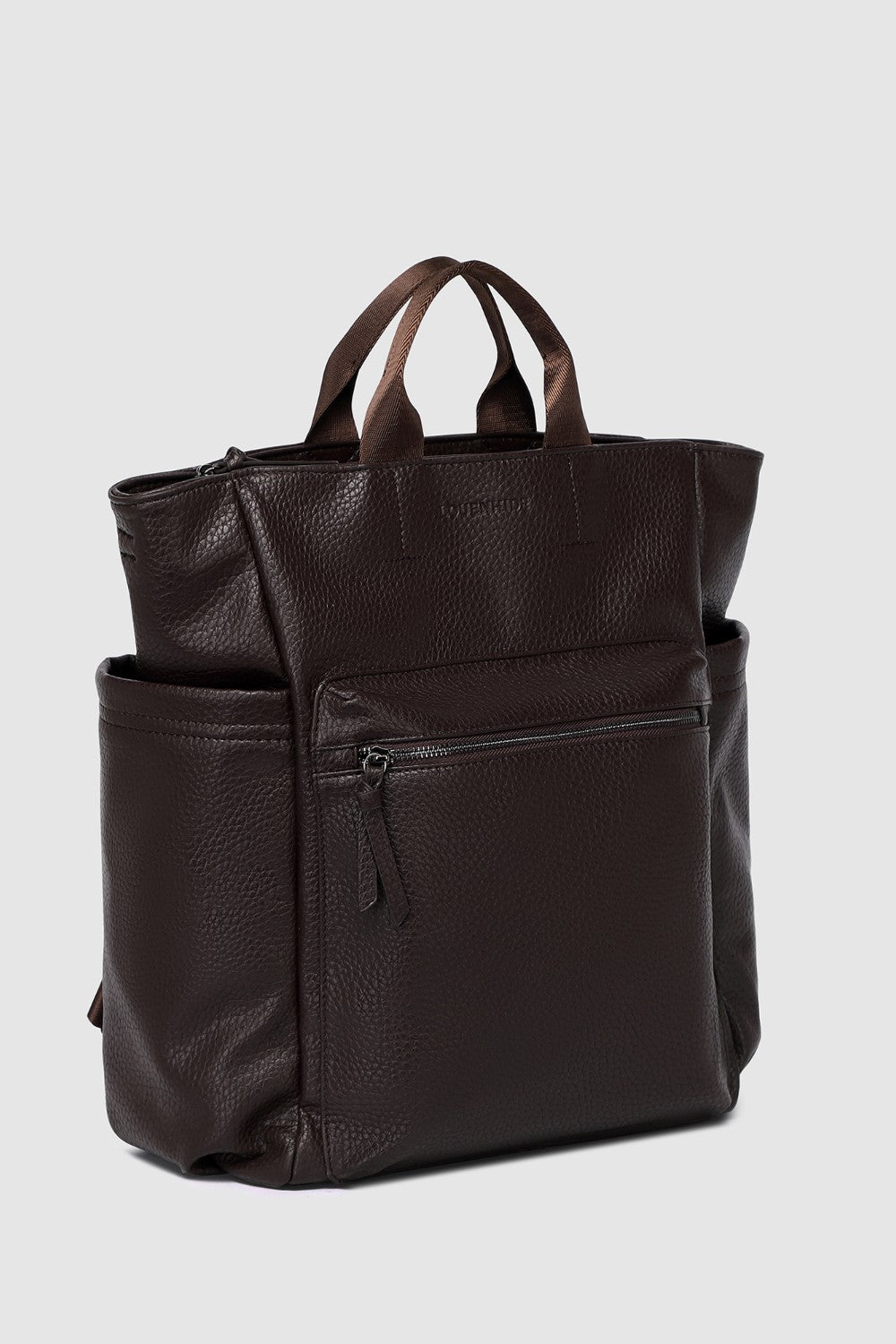 Brown pleather backpack on a light gray background