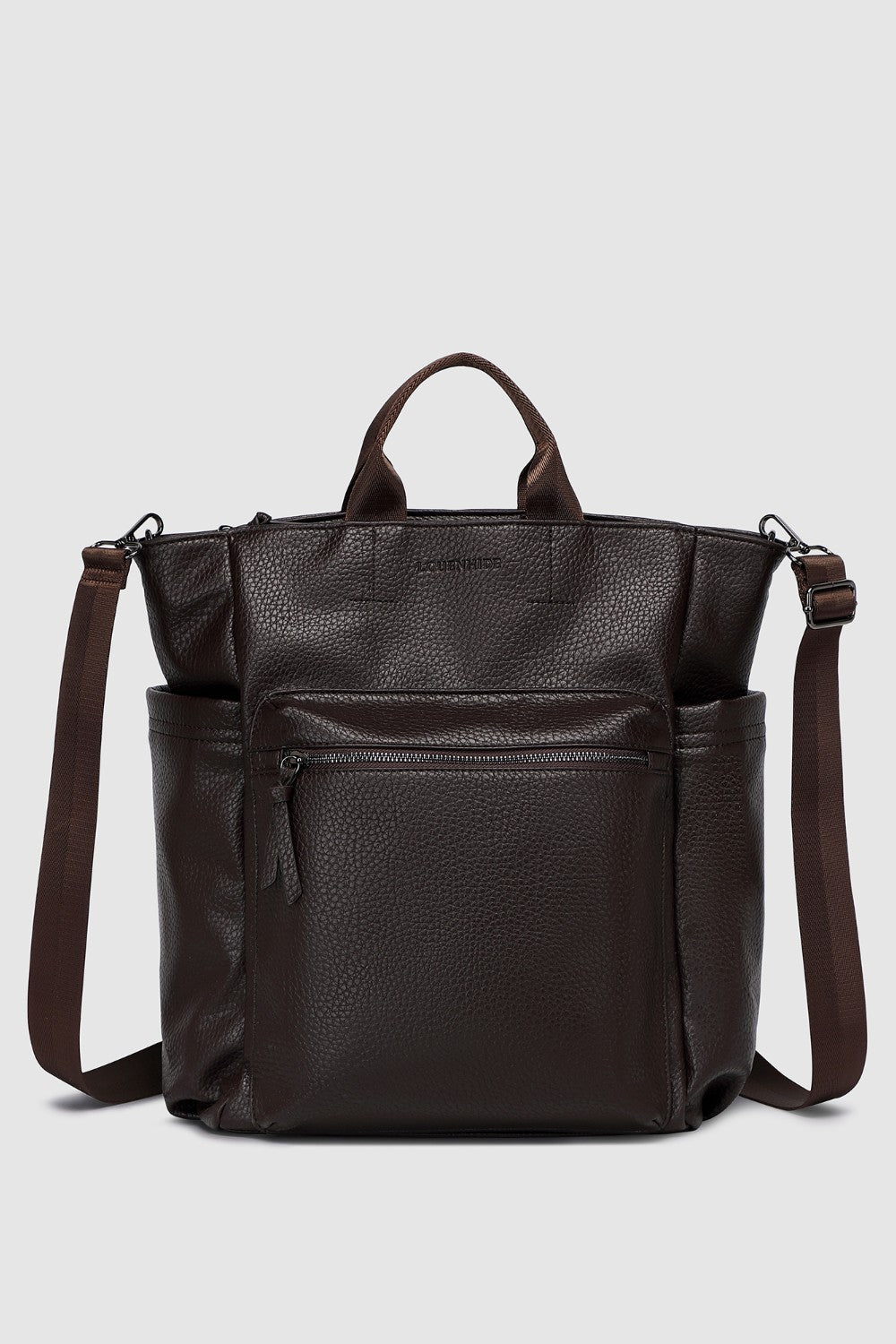 Brown pleather backpack with multiple pockets on a light gray background