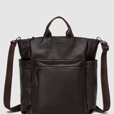 Brown pleather backpack with multiple pockets on a light gray background