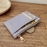 Lilac wallet with gold accents on a wooden surface