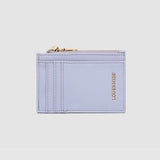 Lilac cardholder with gold zipper on a light gray background