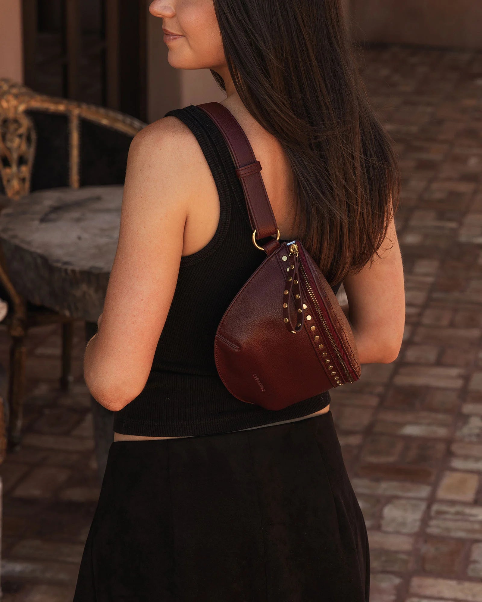 The Louenhide Cassidy Belt Bag is a bold staple designed to add a statement finish to your everyday styling. Crafted in a structured faux leather and adorned with refined hardware accents, this studded bag blends functionality with elevated design.