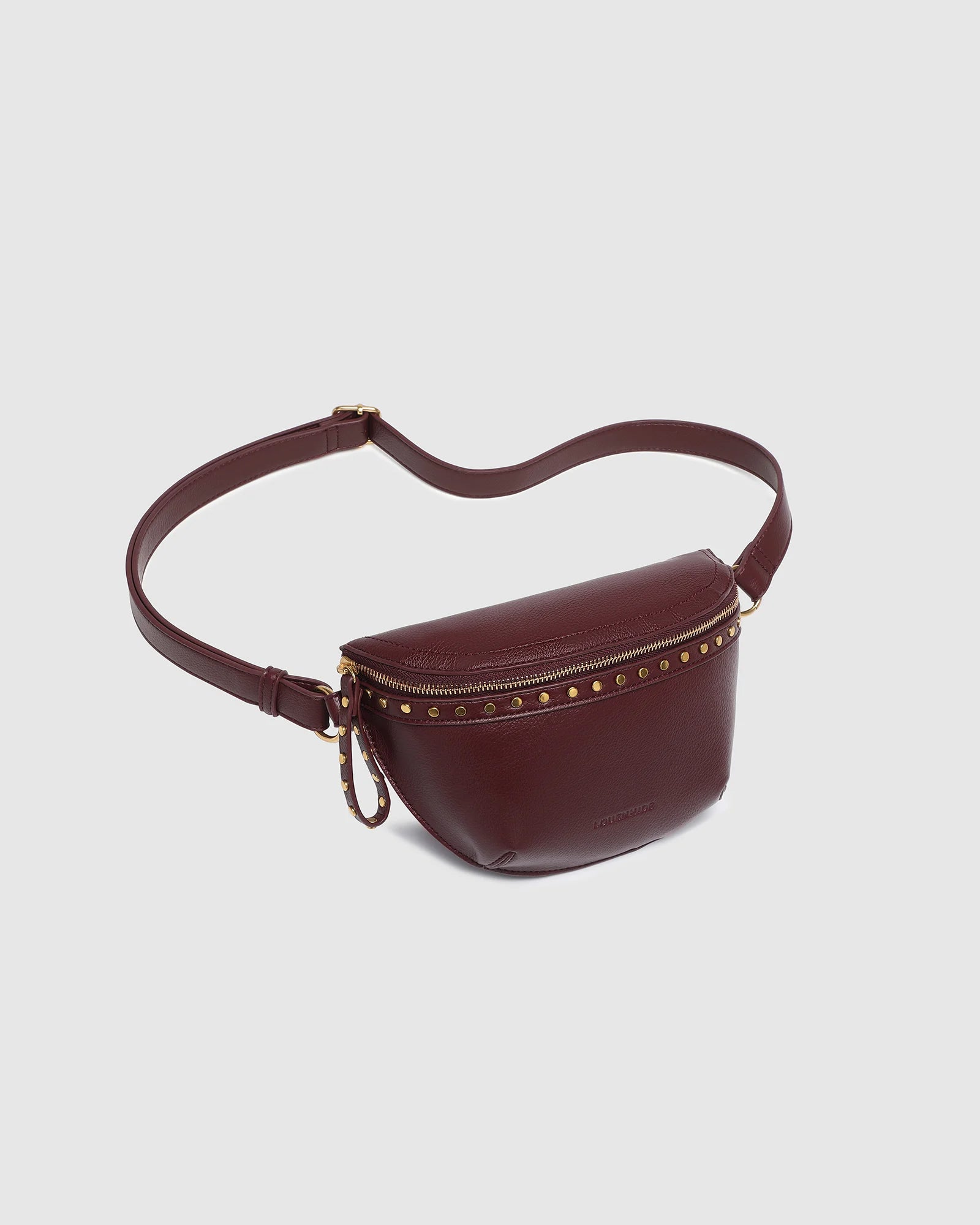 The Louenhide Cassidy Belt Bag is a bold staple designed to add a statement finish to your everyday styling. Crafted in a structured faux leather and adorned with refined hardware accents, this studded bag blends functionality with elevated design.
