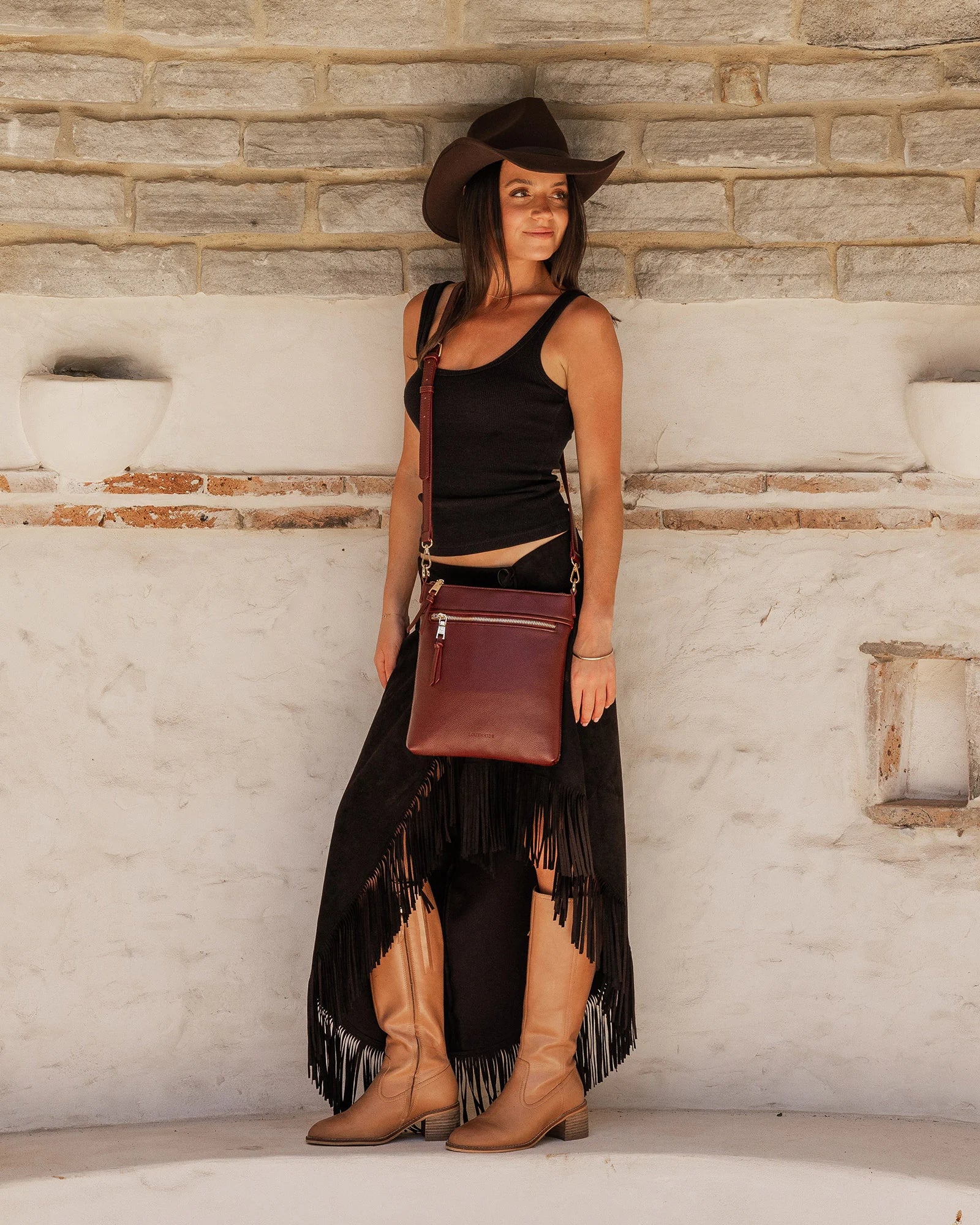 The Louenhide Cressida Crossbody Bag is your go-to for everyday ease and streamlined functionality. Designed in rich, seasonal hues, this crossbody handbag is both timeless and practical. The structured silhouette offers a spacious interior to keep your daily essentials organized, while the secure zip closures ensure everything stays in place. Whether worn over the shoulder or across the body, the adjustable strap lets you tailor the fit to suit your day. With subtle design detailing and a sleek shape, this