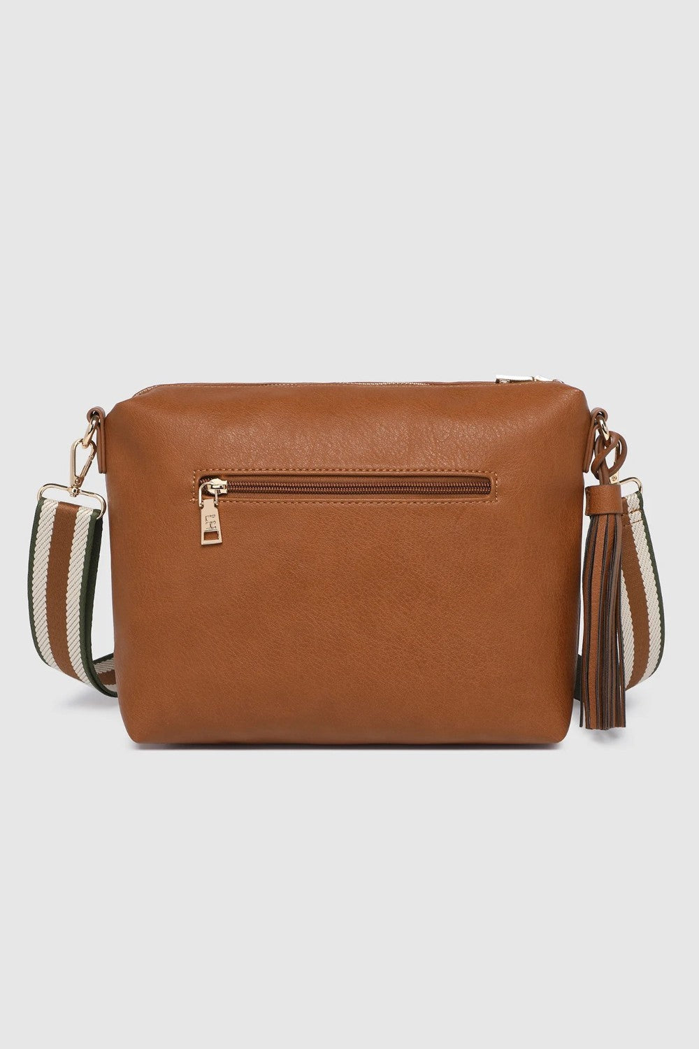A brown faux-leather crossbody bag with a outside zip pocket, featuring a striped woven strap and a tassel detail, shown against a light gray background.
