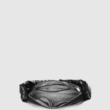 Looking down on an open black handbag with striped lining and silver zip closure