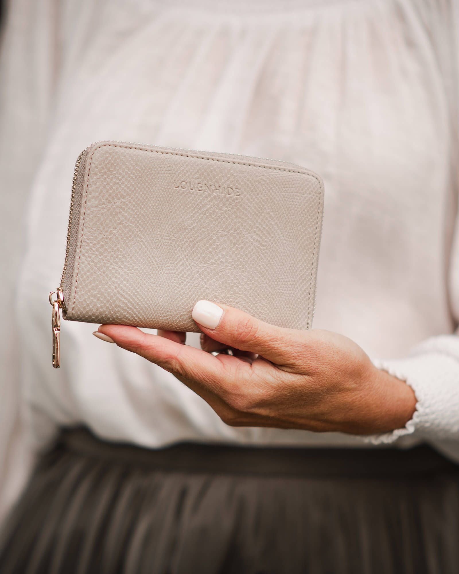 The Louenhide Eden Wallet is where functional simplicity meets enduring style. This classic everyday essential showcases a minimalistic design and clean lines on a smooth vegan leather exterior. Despite its compact size, the classic silhouette boasts ample space for your essentials. Stay organized at your convenience with multiple card holders, a dedicated slip pocket for your notes and receipts, and a zipped coin pocket to ensure you carry what you need without unnecessary bulk.