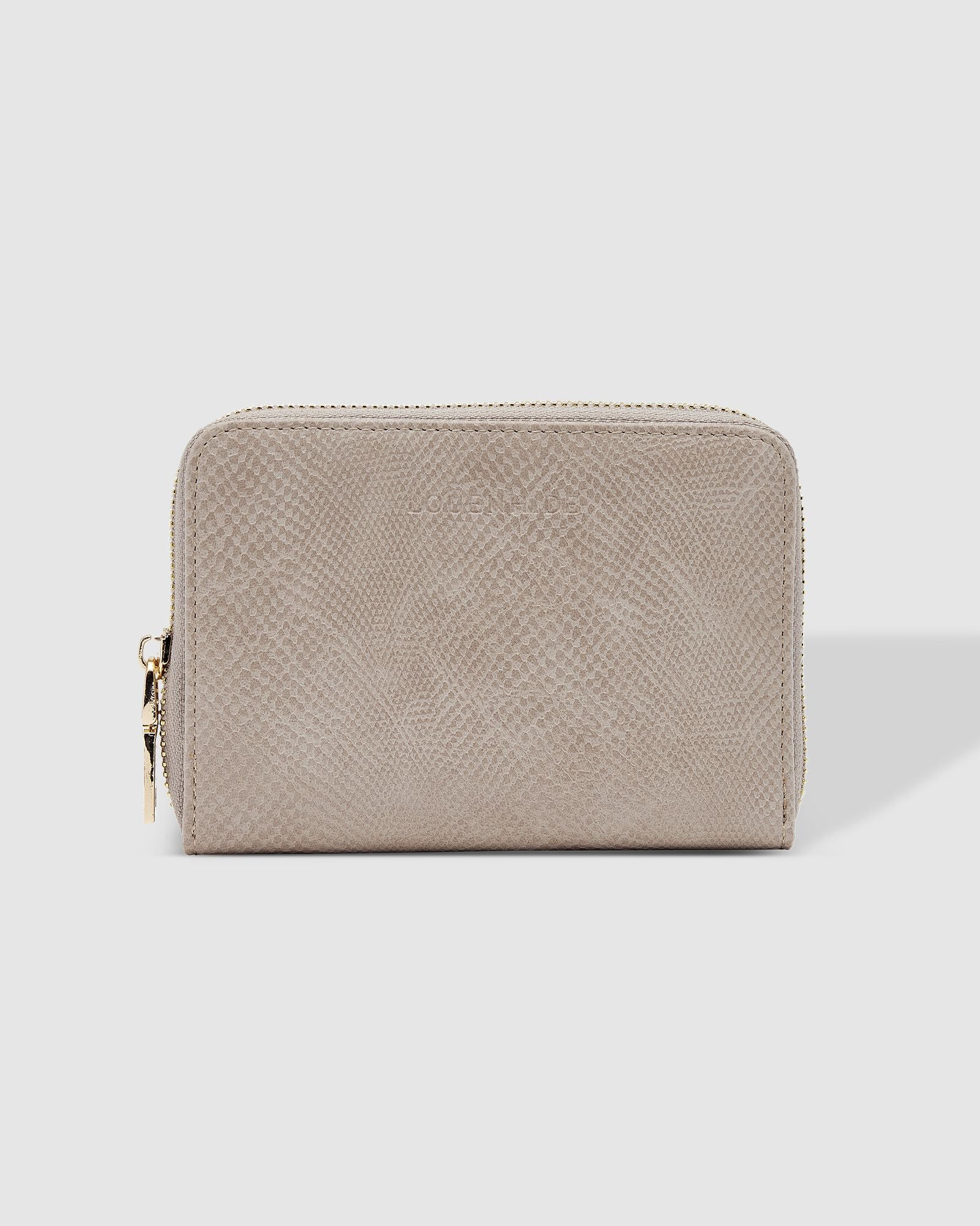 The Louenhide Eden Wallet is where functional simplicity meets enduring style. This classic everyday essential showcases a minimalistic design and clean lines on a smooth vegan leather exterior. Despite its compact size, the classic silhouette boasts ample space for your essentials. Stay organized at your convenience with multiple card holders, a dedicated slip pocket for your notes and receipts, and a zipped coin pocket to ensure you carry what you need without unnecessary bulk.