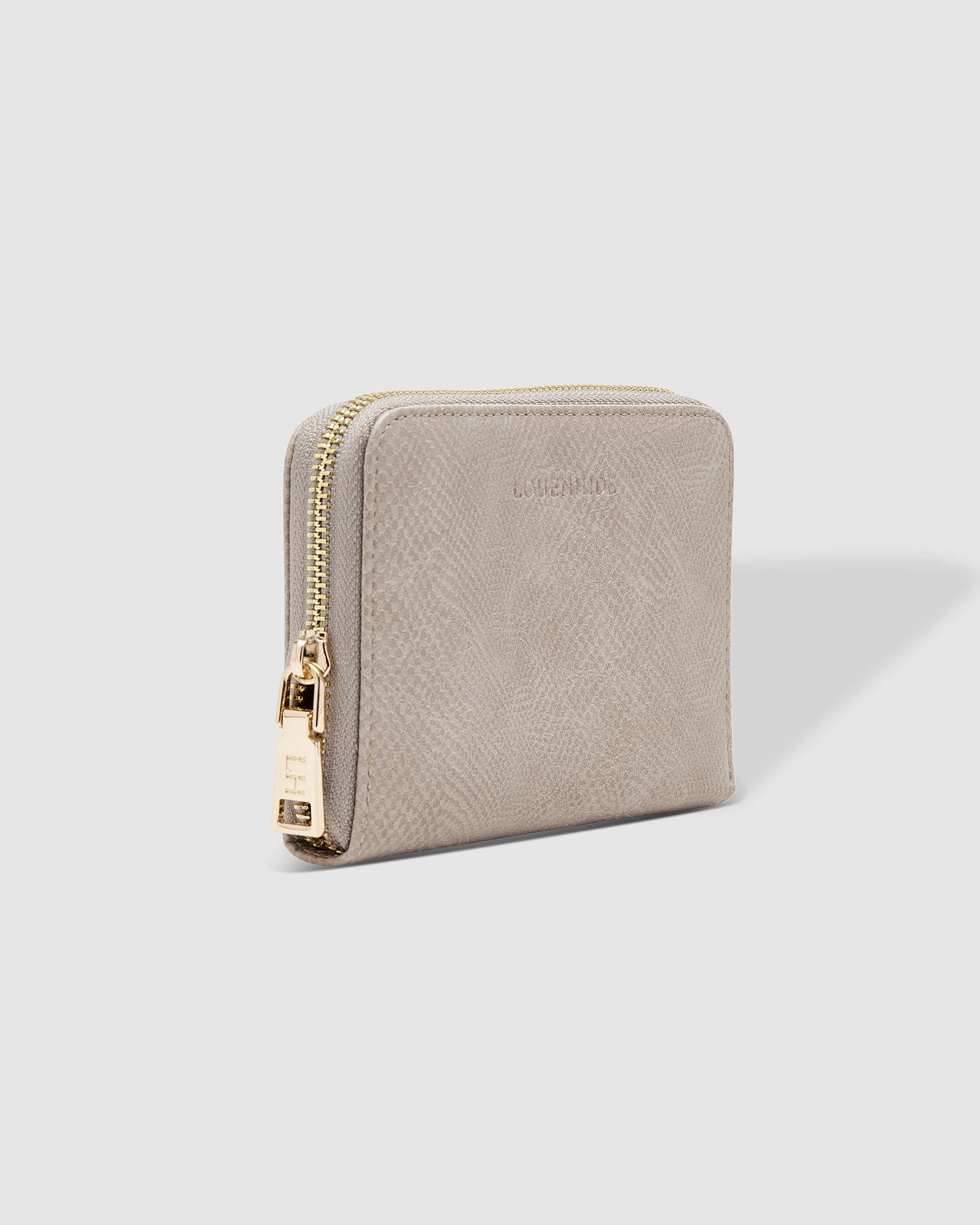 The Louenhide Eden Wallet is where functional simplicity meets enduring style. This classic everyday essential showcases a minimalistic design and clean lines on a smooth vegan leather exterior. Despite its compact size, the classic silhouette boasts ample space for your essentials. Stay organized at your convenience with multiple card holders, a dedicated slip pocket for your notes and receipts, and a zipped coin pocket to ensure you carry what you need without unnecessary bulk.