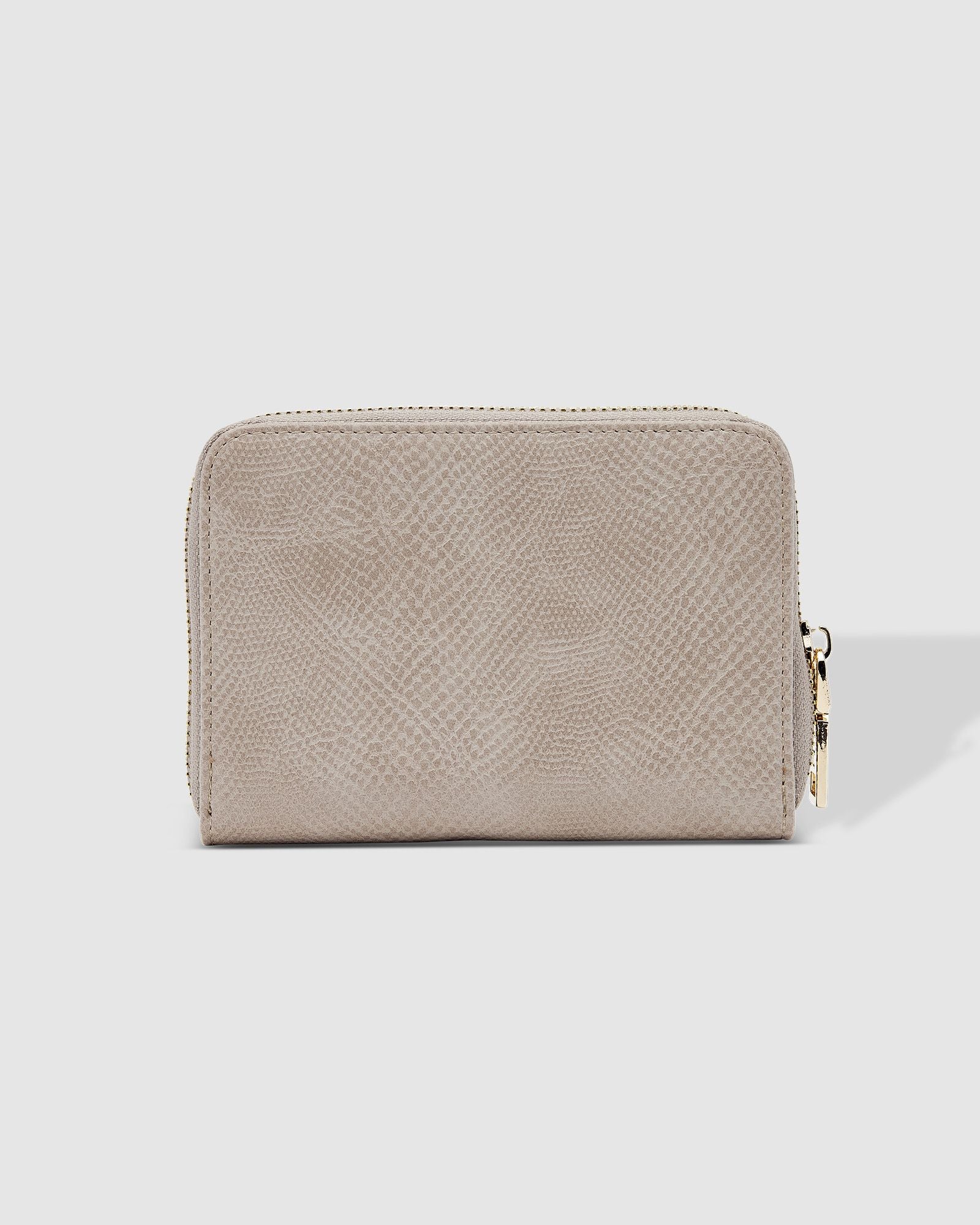 The Louenhide Eden Wallet is where functional simplicity meets enduring style. This classic everyday essential showcases a minimalistic design and clean lines on a smooth vegan leather exterior. Despite its compact size, the classic silhouette boasts ample space for your essentials. Stay organized at your convenience with multiple card holders, a dedicated slip pocket for your notes and receipts, and a zipped coin pocket to ensure you carry what you need without unnecessary bulk.